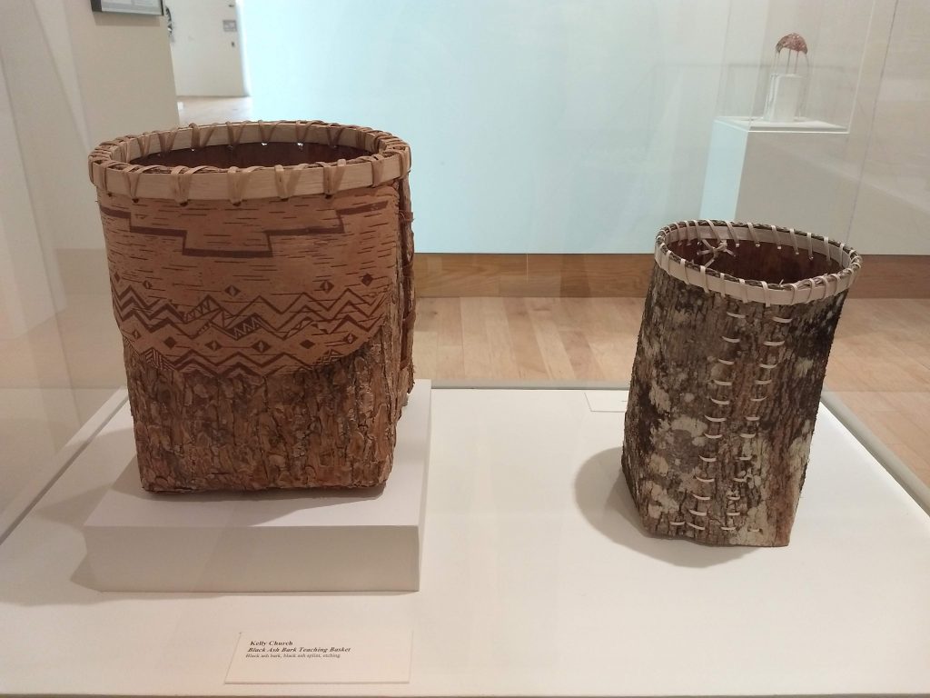 Two bark baskets in a display case.