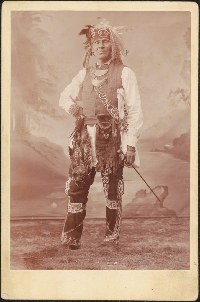 Black and white photograph of a man in chiefly regalia.